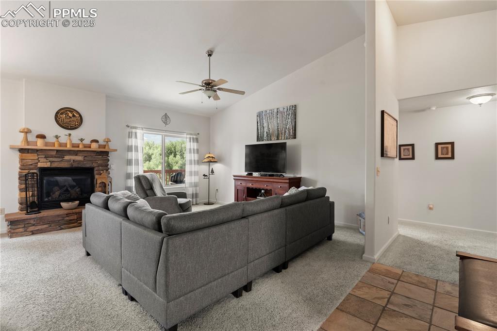 Image 5 of 27: The living room features a gas fireplace and vaulted ceilings.
