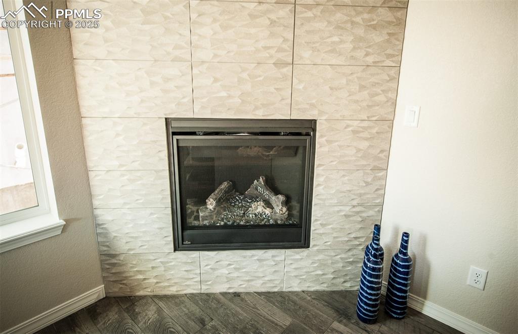 Image 13 of 48: Gas fireplace with tile surround