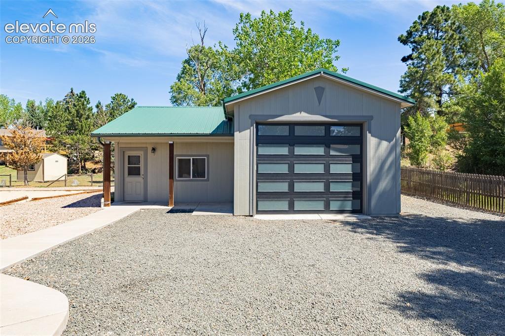 Image 3 of 38: Detached structure featuring a 12 foot garage door, plumbing, electricity