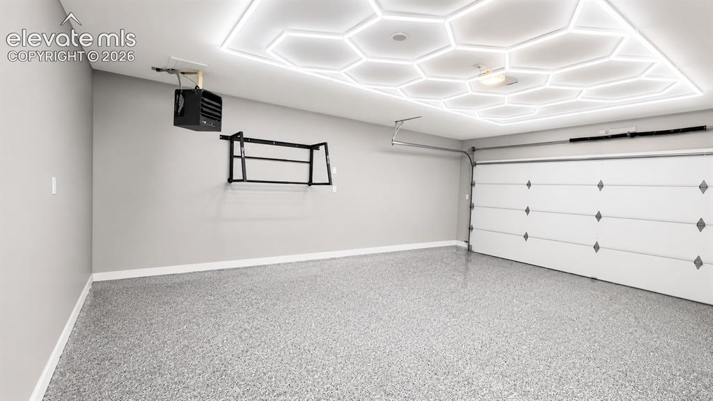 Image 7 of 38: attached garage with epoxy floors, heating, cold plunge, and lighting
