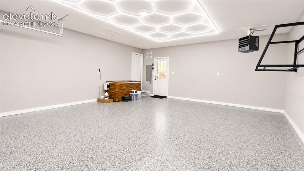 Image 8 of 38: attached garage with epoxy floors, heating, cold plunge, and lighting