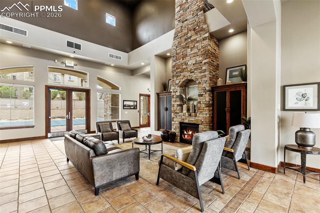 Image 26 of 29: Gathering area with stone fireplace for events