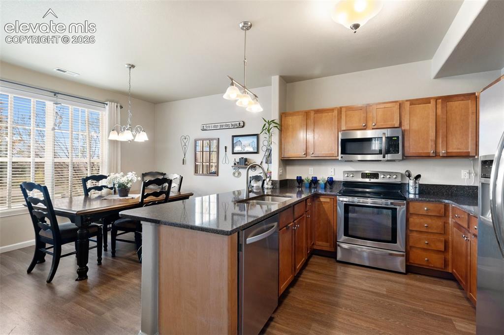Image 3 of 29: Kitchen and dining with a breakfast bar
