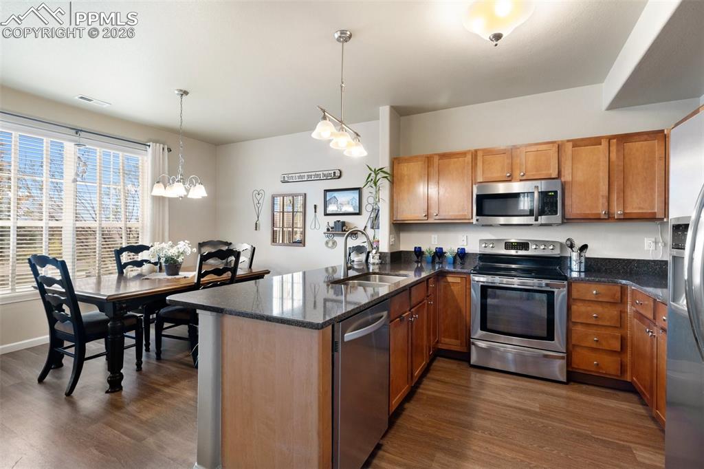 Image 4 of 29: Kitchen and dining with a breakfast bar