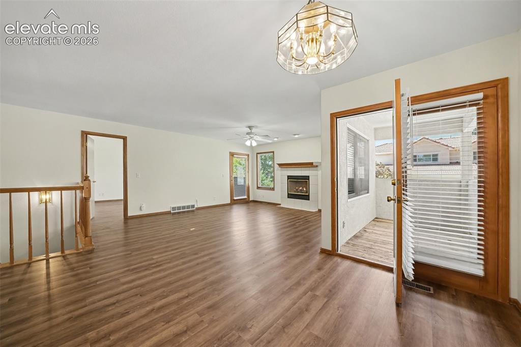 Image 14 of 47: Spacious living area featuring new paint and new LVP flooring, a built-in g