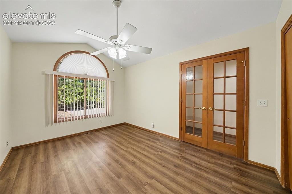 Image 16 of 47: Vaulted ceiling with a ceiling fan, LVP flooring, French doors, and a large