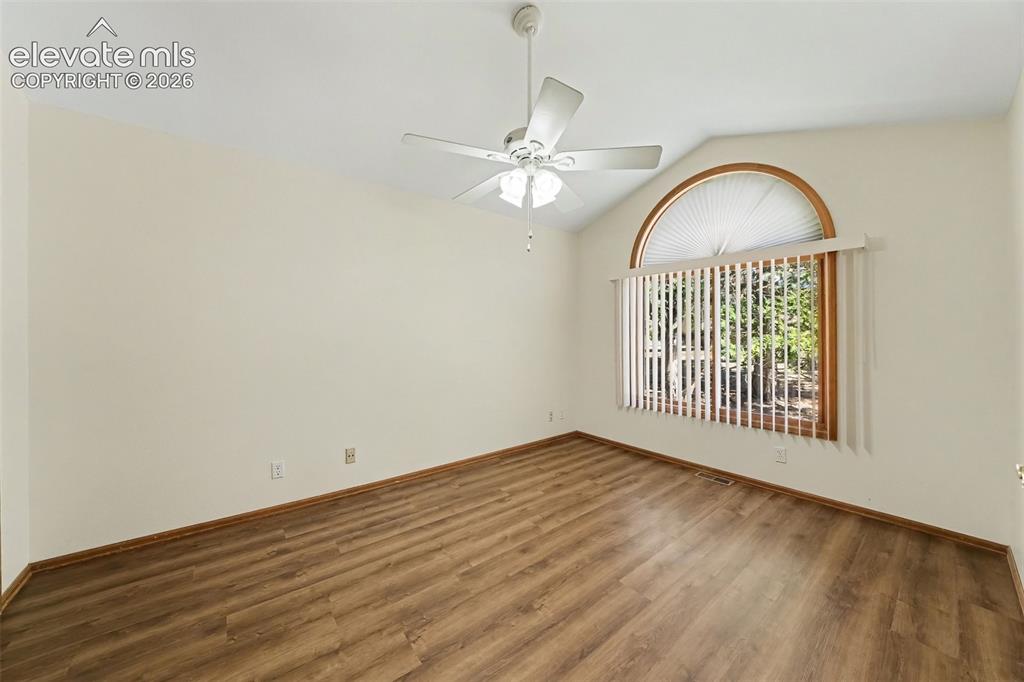 Image 17 of 47: Vaulted ceiling with a ceiling fan, LVP flooring, French doors, and a large