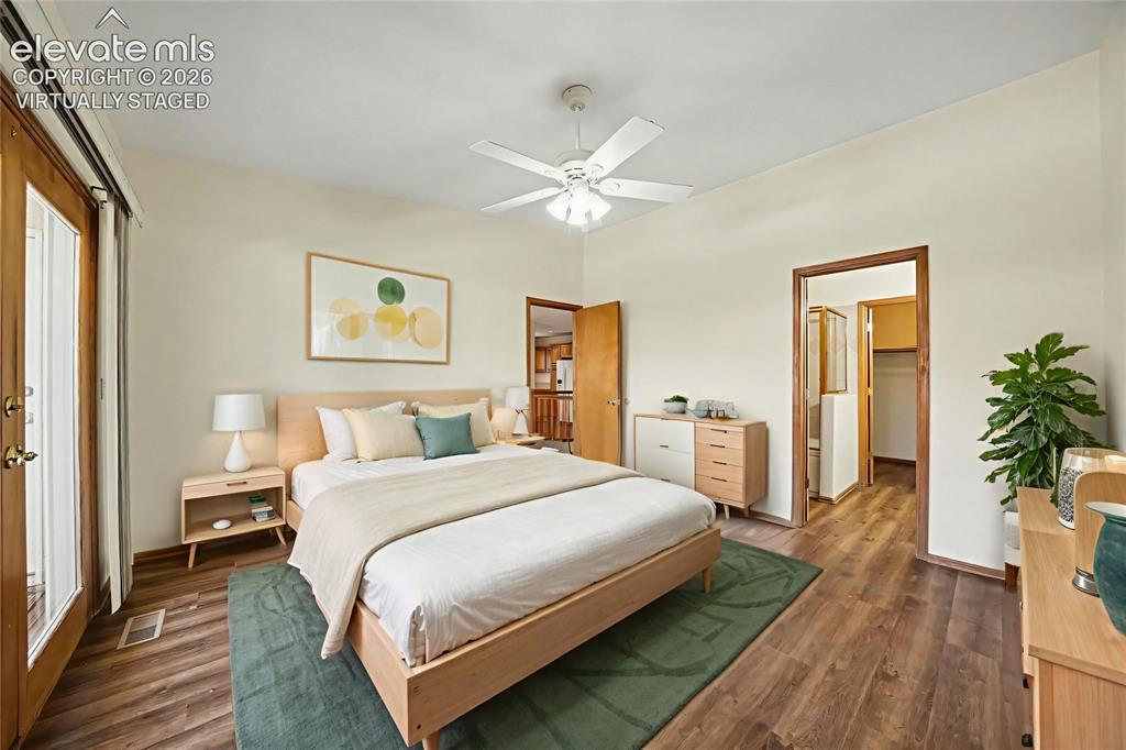 Image 19 of 47: Virtually staged. LVP flooring, ceiling fan, and light-tone walls with walk