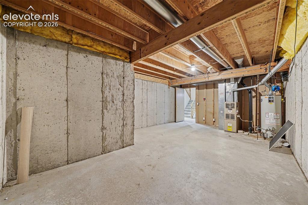 Image 37 of 47: Unfinished concrete basement with exposed ceiling joists