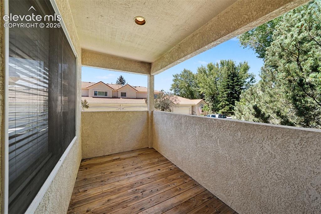 Image 38 of 47: Balcony featuring a wood-finish floor, textured exterior walls, and a reces