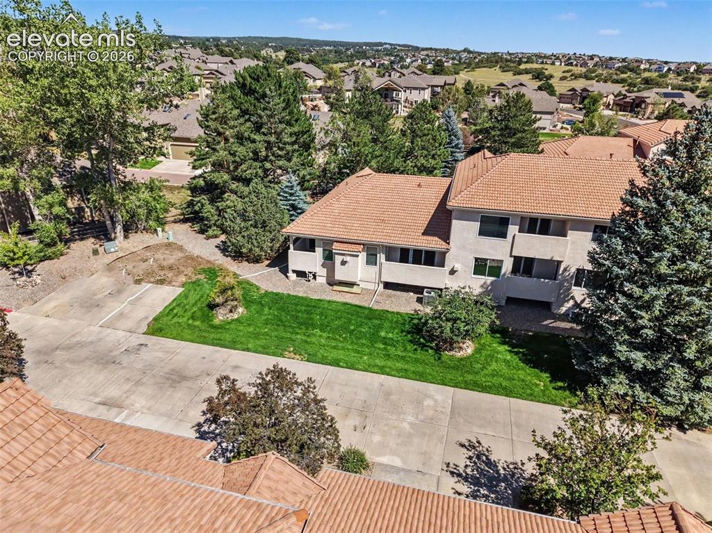 Image 41 of 47: Stucco exterior residence featuring a tiled roof, multiple windows, and a c
