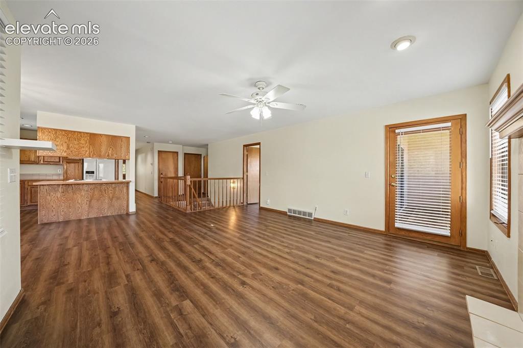 Image 8 of 47: New paint and LVP flooring throughout, recessed lighting, and a ceiling fan
