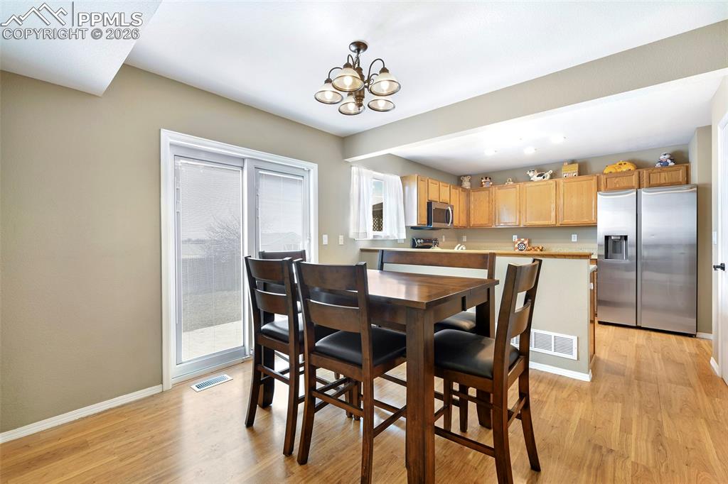 Image 12 of 30: Dining Room With Patio Doors to Rear Yard And Patio  