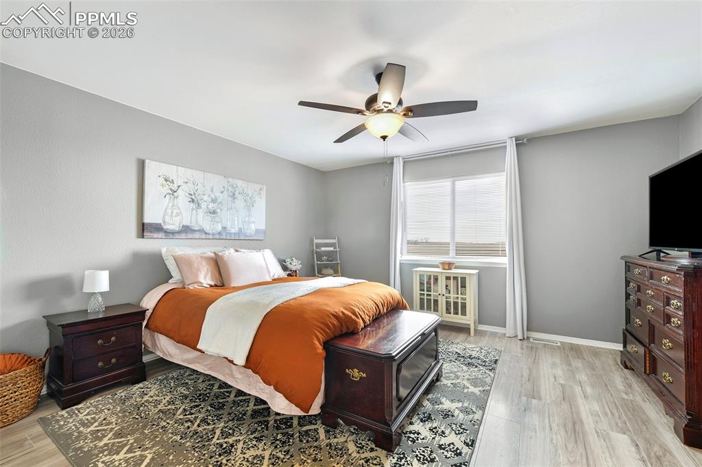 Image 18 of 30: Primary Bedroom At Rear Of Home With Views From Windows Into Open Space Beh