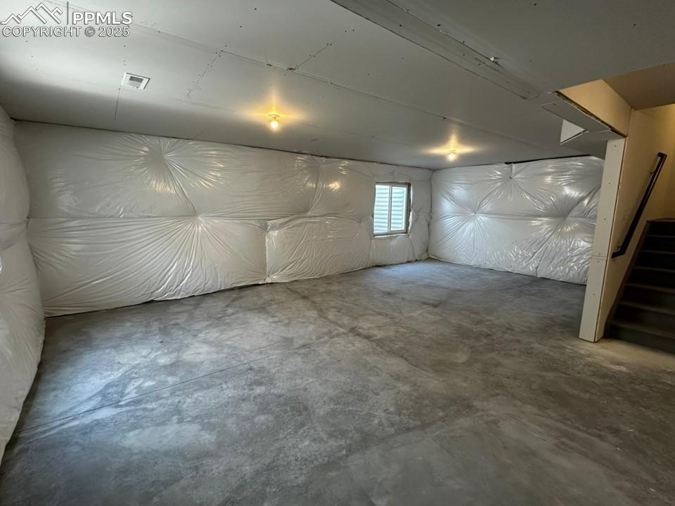 Image 13 of 14: Below grade area with stairway