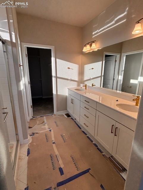 Image 5 of 14: Full bathroom with a walk in closet and double vanity
