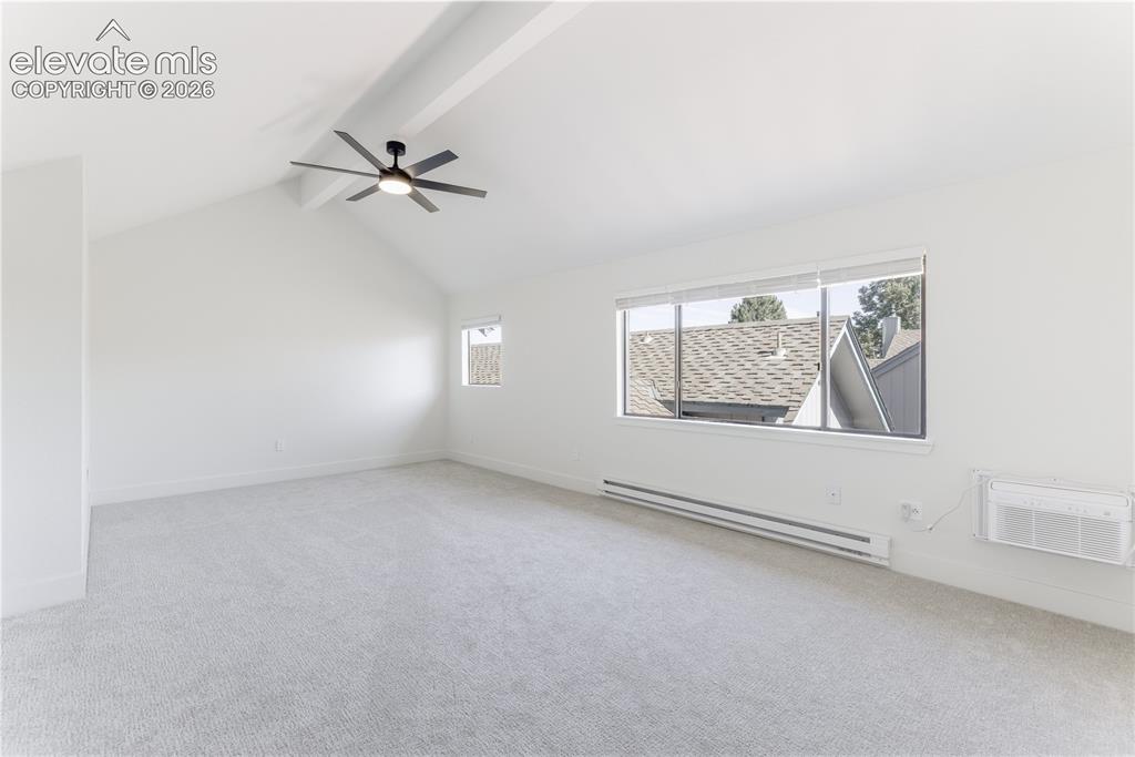 Image 19 of 28: Vaulted ceilings featuring a matte black multi-blade ceiling fan, expansive