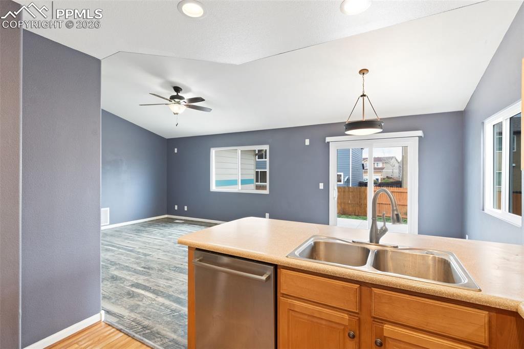 Image 4 of 21: Kitchen with a view of living and dining area