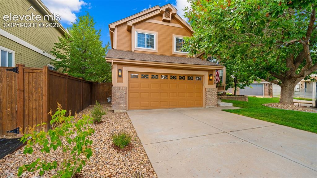 Image 1 of 30: Two-story residence featuring a two-car garage with decorative windows and