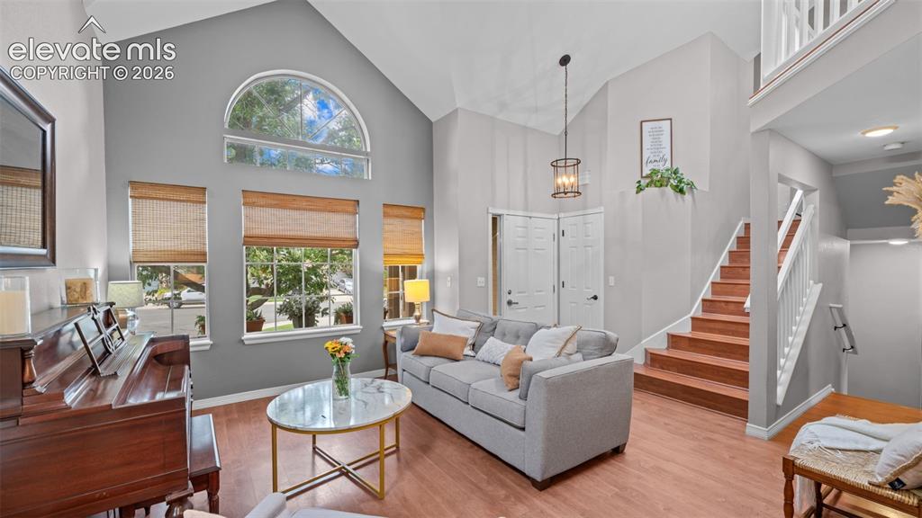 Image 7 of 30: Vaulted ceilings complement the grand arched window and multiple rectangula
