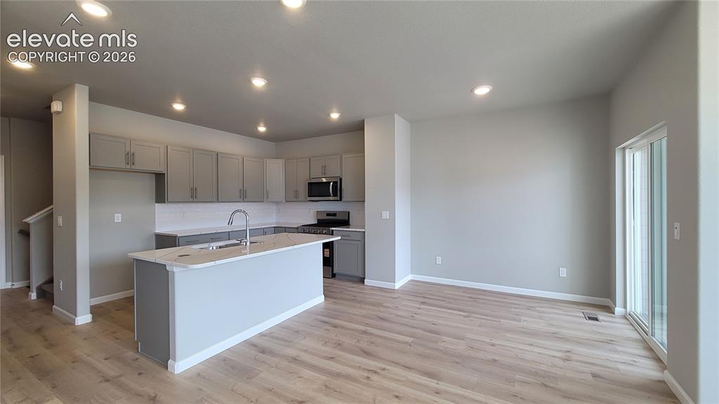Image 10 of 36: Dining area with LVP flooring and walks out to composite deck!