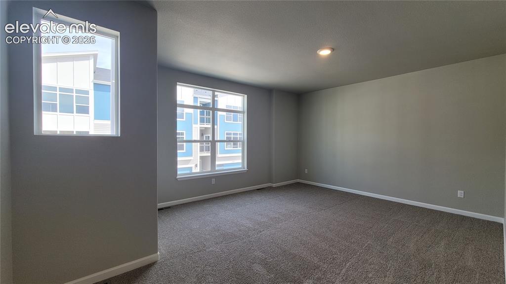Image 14 of 36: Spacious Primary Suite is accompanied with a plush bathroom and walk-in clo