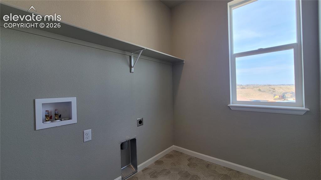 Image 23 of 36: Conveniently located laundry room on the upper level with a window!