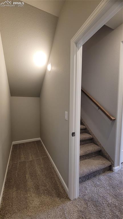 Image 28 of 29: Shelving at the bottom of the stairs and a finished storage closet, located