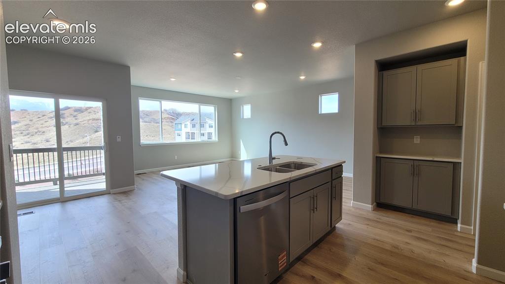 Image 8 of 36: Kitchen with Quartz countertops, pantry, large island, and stainless steel