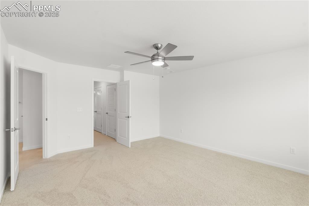Image 10 of 39: Unfurnished bedroom featuring light colored carpet and ceiling fan