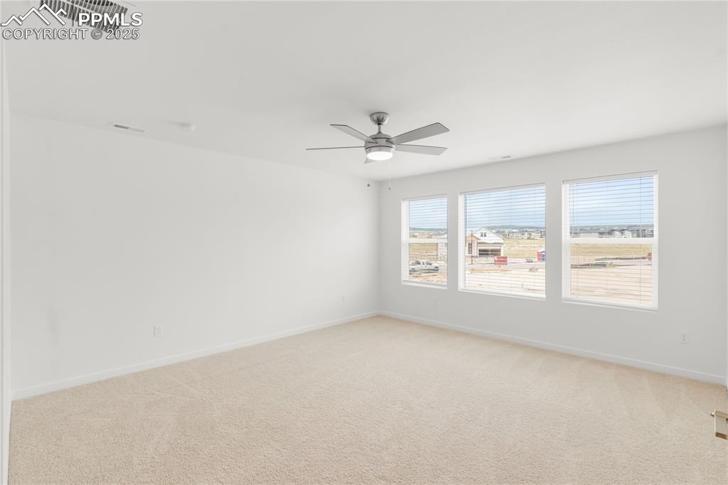 Image 11 of 39: Spare room with light colored carpet and a ceiling fan
