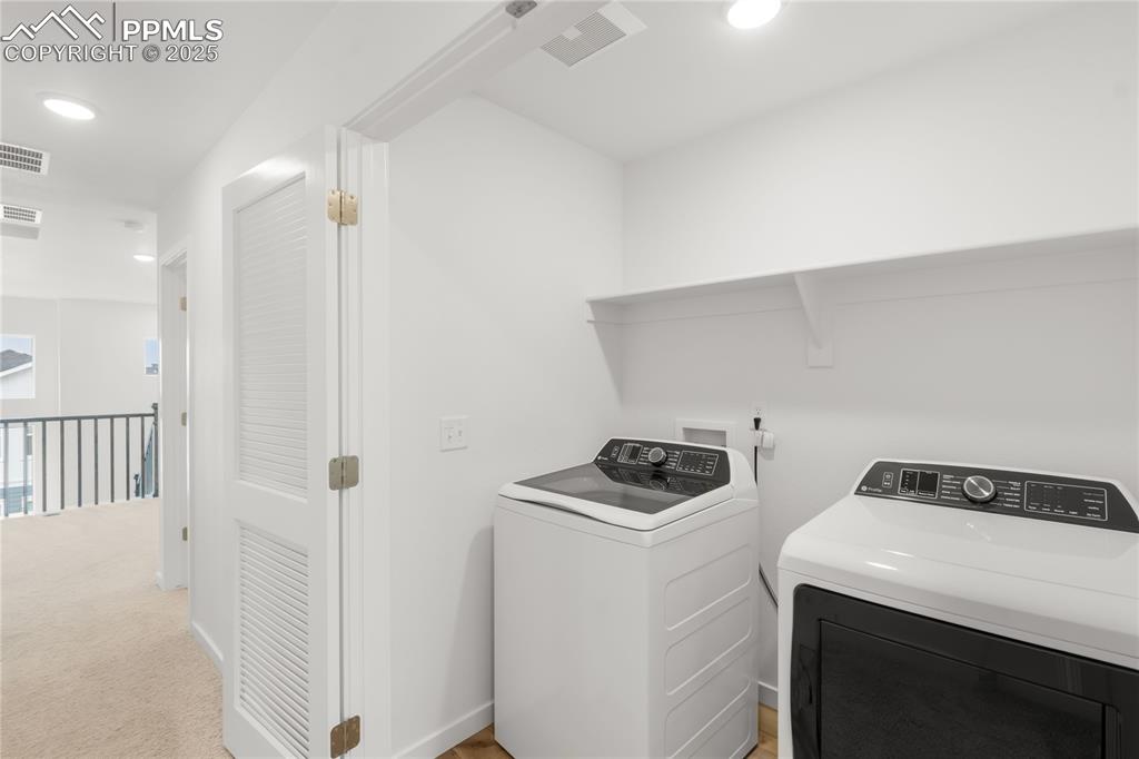 Image 14 of 39: Washroom featuring washing machine and clothes dryer, recessed lighting, an