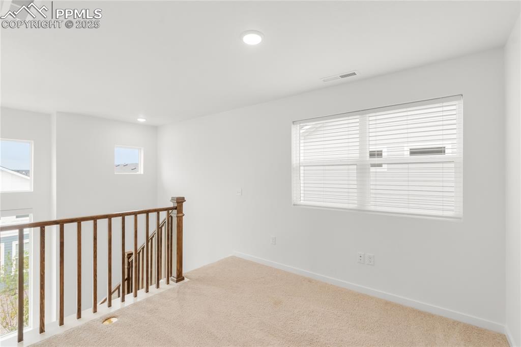 Image 16 of 39: Carpeted spare room with recessed lighting