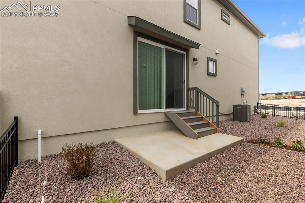Image 37 of 39: Back of property with stucco siding and a patio