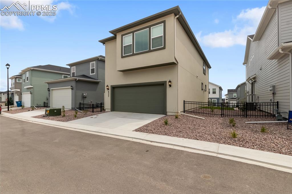 Image 39 of 39: View of front of house featuring stucco siding, a residential view, an atta