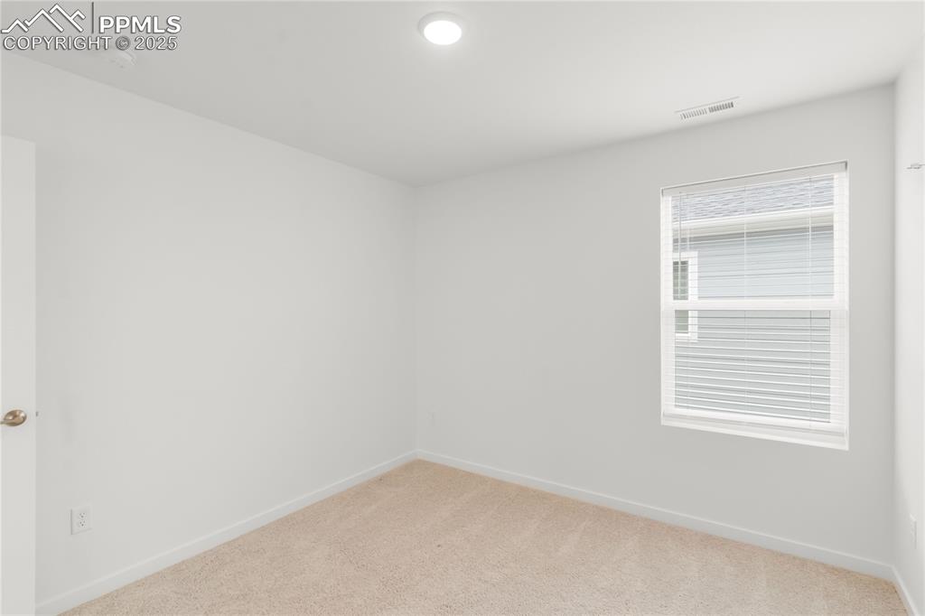Image 4 of 39: Spare room featuring light colored carpet and baseboards