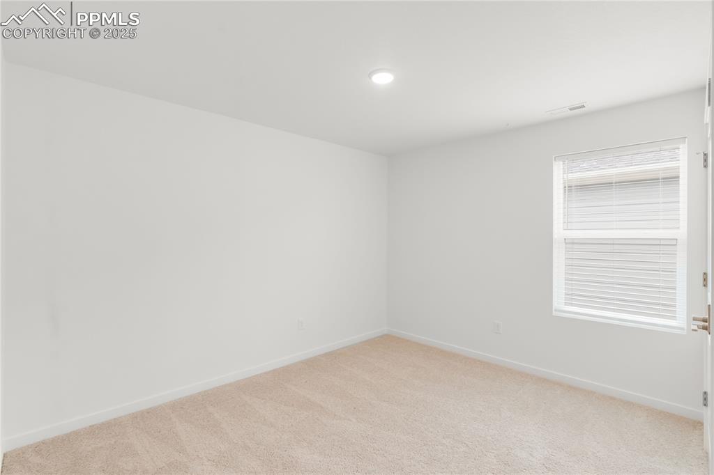 Image 5 of 39: Unfurnished room with light carpet