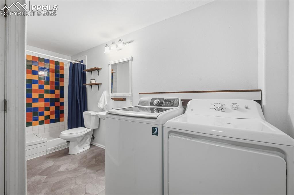 Image 33 of 50: Lower Level Laundry & 3/4 Bath