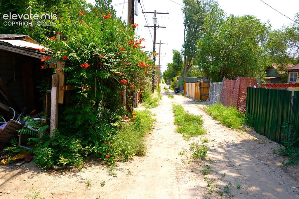 Image 19 of 19: back alley (parking space next to shed)