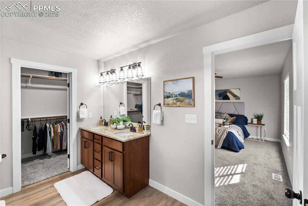 Image 18 of 31: double sinks and walk-in closet