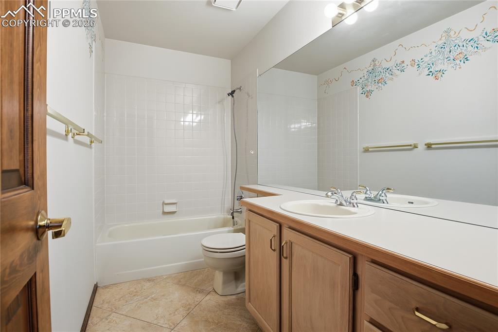 Image 29 of 47: Bathroom with vanity, shower / bath combo with shower curtain, and light ti