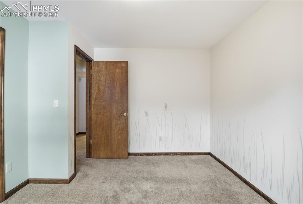 Image 42 of 47: Empty room featuring carpet flooring and baseboards