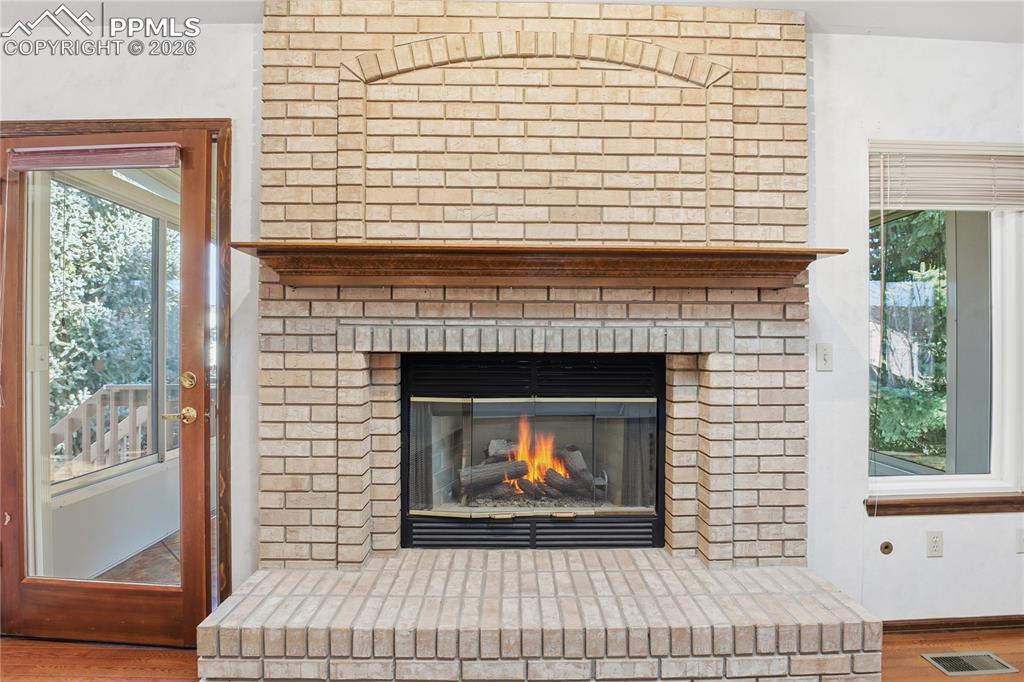 Image 7 of 47: Detailed view of wood finished floors and a fireplace