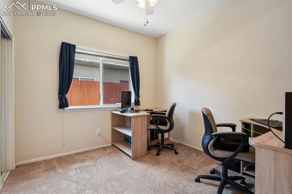Image 22 of 29: Carpeted office with ceiling fan