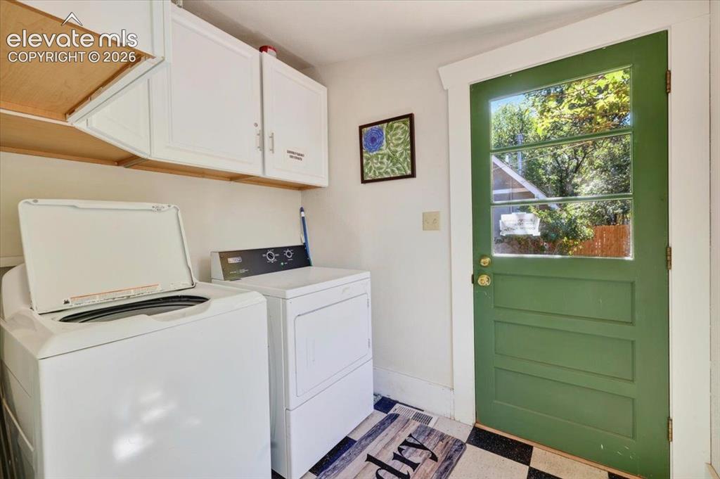 Image 11 of 50: Laundry Room – Dedicated laundry room with washer, dryer, storage cabinetry