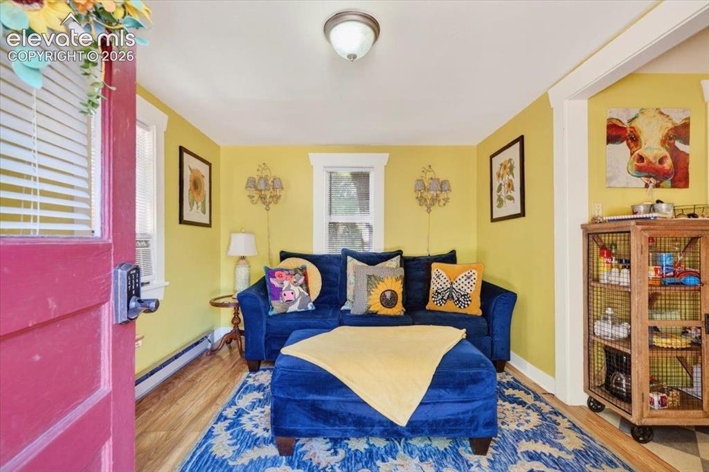 Image 14 of 50: Sunflower Cottage Living Area – Cozy living room with cheerful décor, abund