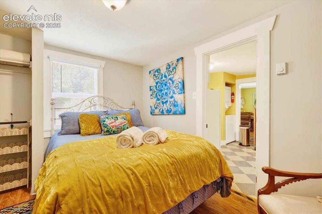 Image 16 of 50: Sunflower Cottage Bedroom – Comfortable bedroom with abundant natural light