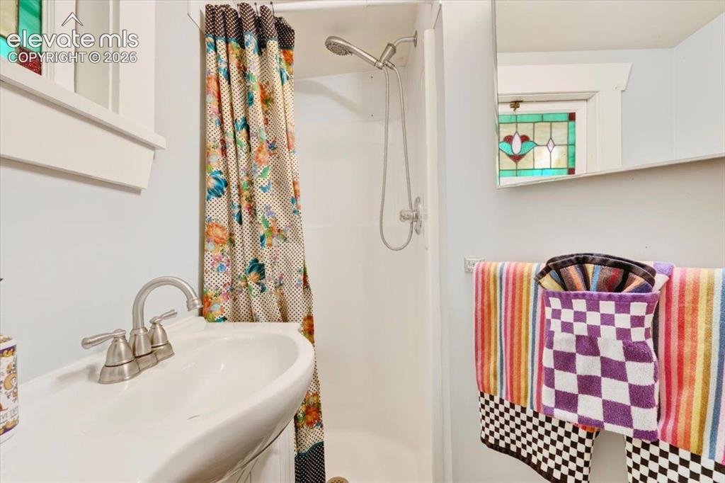 Image 17 of 50: Sunflower Cottage Bathroom – Bright bathroom featuring an updated vanity, w