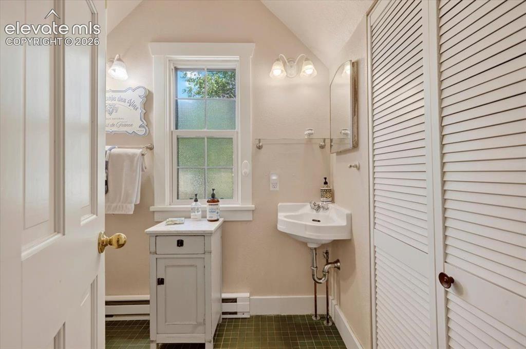 Image 24 of 50: Monet Cottage Bathroom – Clean and functional bathroom featuring classic fi