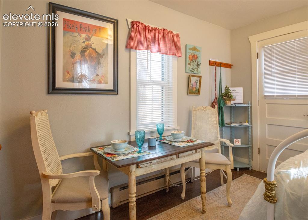 Image 30 of 50: Sweet Rose Dining Nook – Cozy dining area with vintage charm, abundant natu